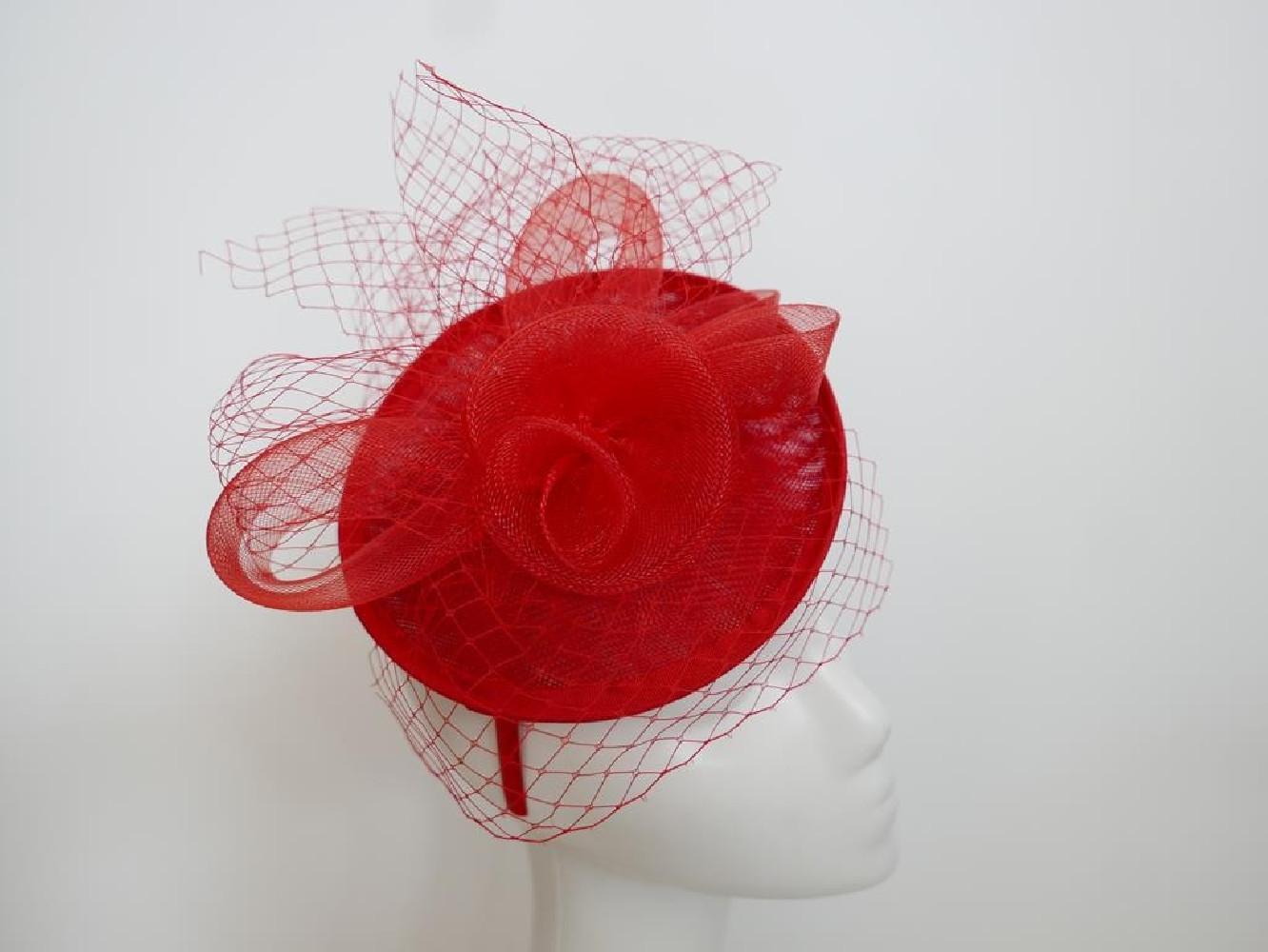 Czerwony fascynator z woalką na przepasce