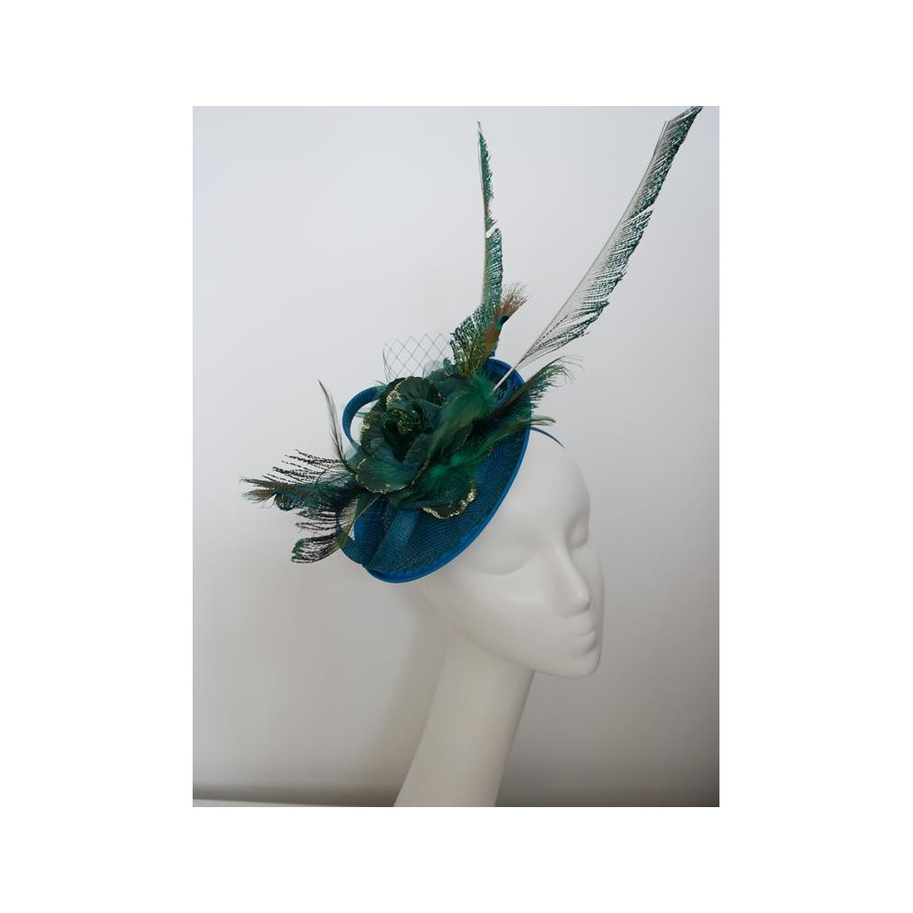 Turkusowo zielony fascynator z piórami i woalką na przepasce