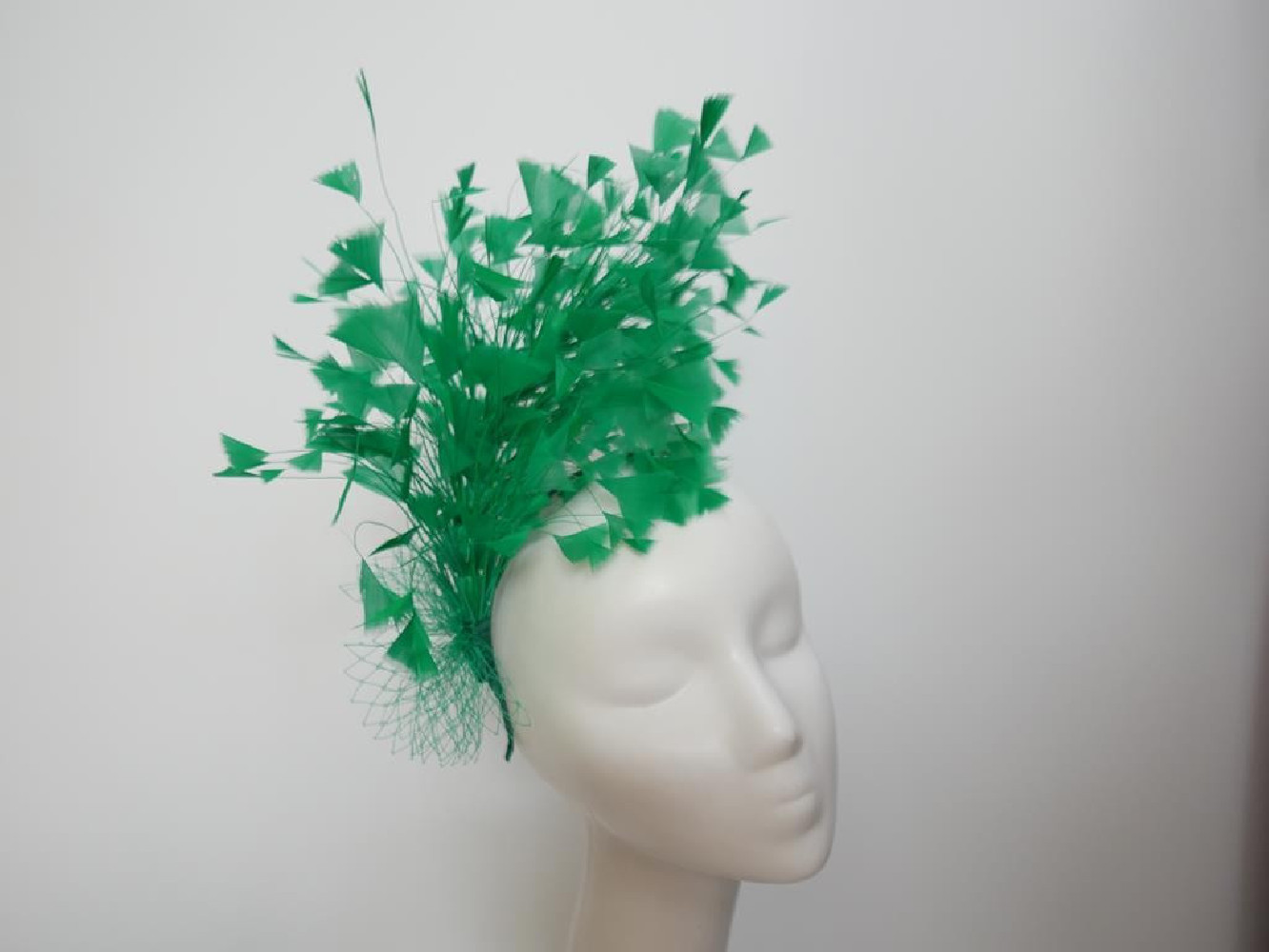 Soczyście zielony fascynator z piór z woalką