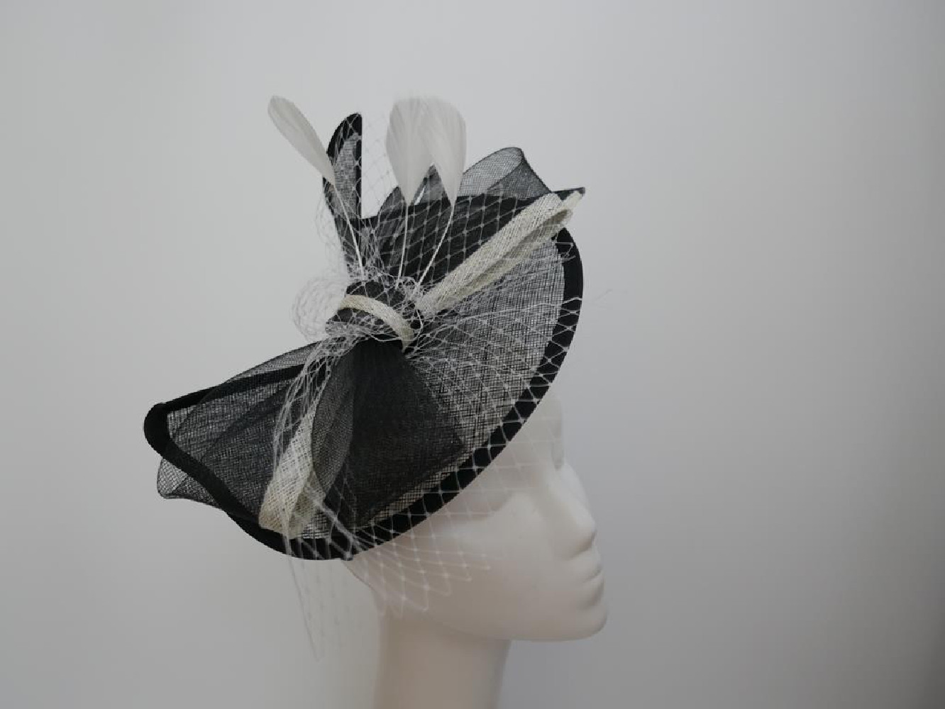 Czarno śmietankowy fascynator z sinamay z piórami na przepasce