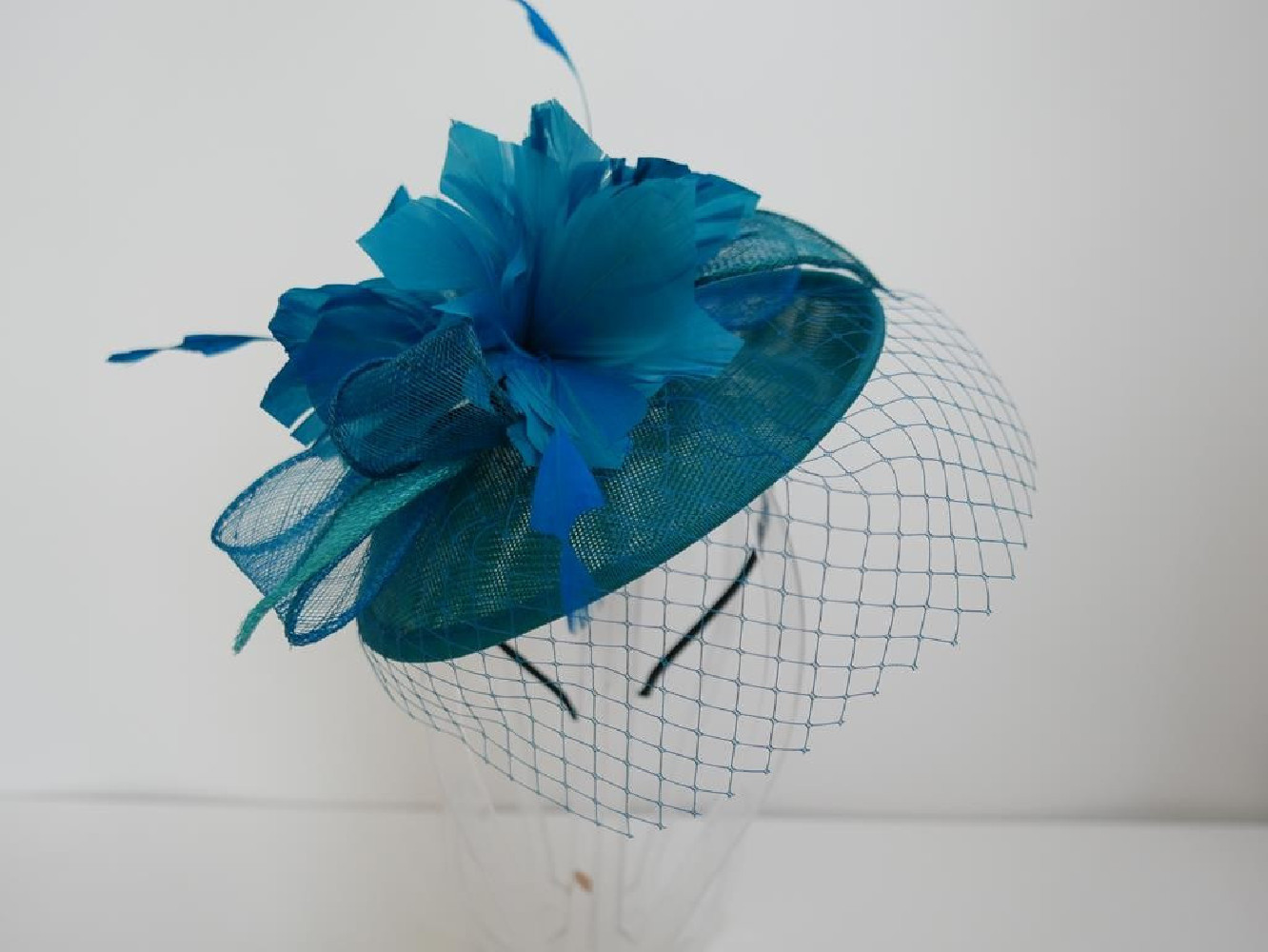 Morski kapelusik koktailowy z lnu z piórami na przepasce